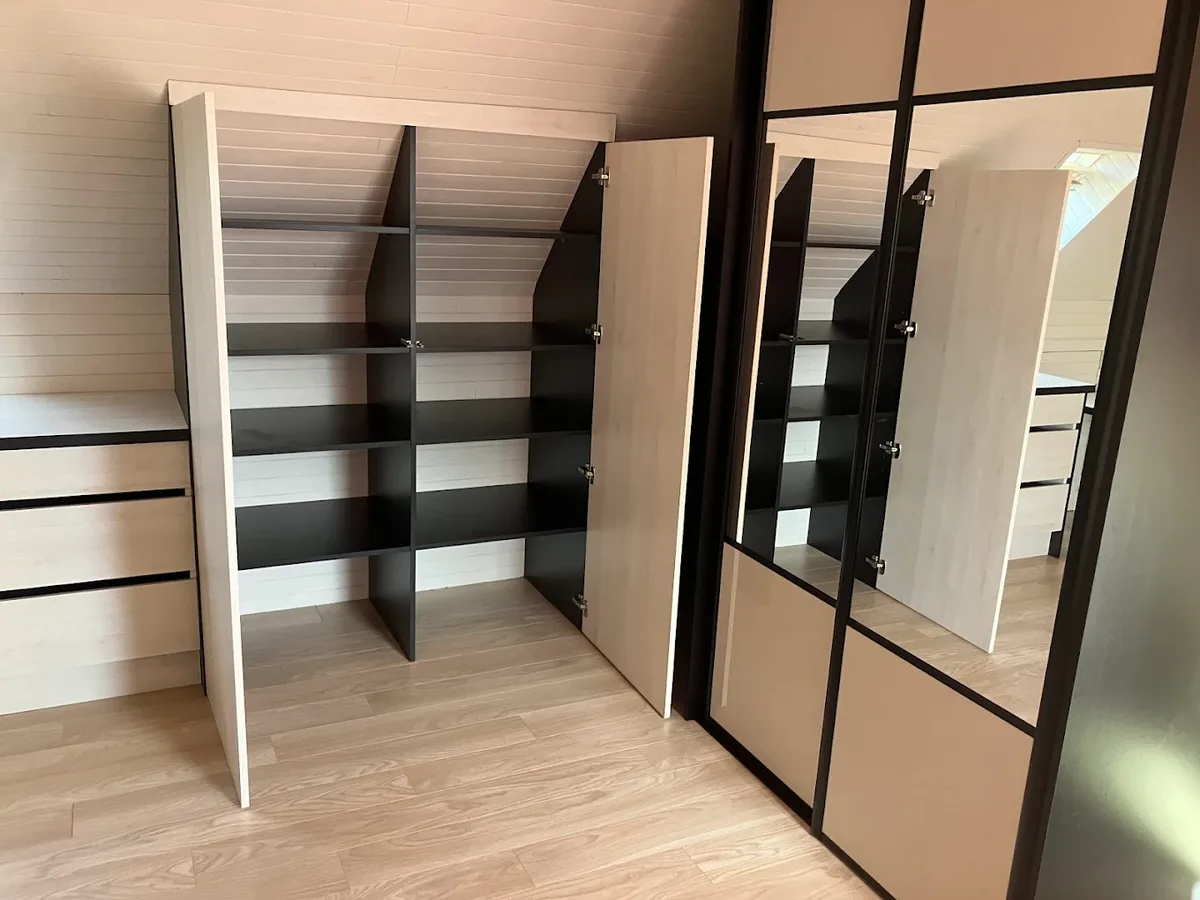 Sloped-ceiling dressing room with storage and mirrored doors