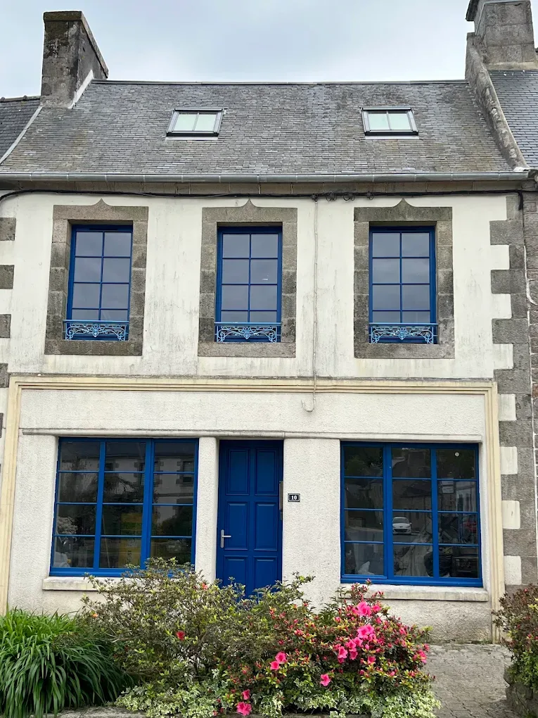 Stone house facade with blue joinery