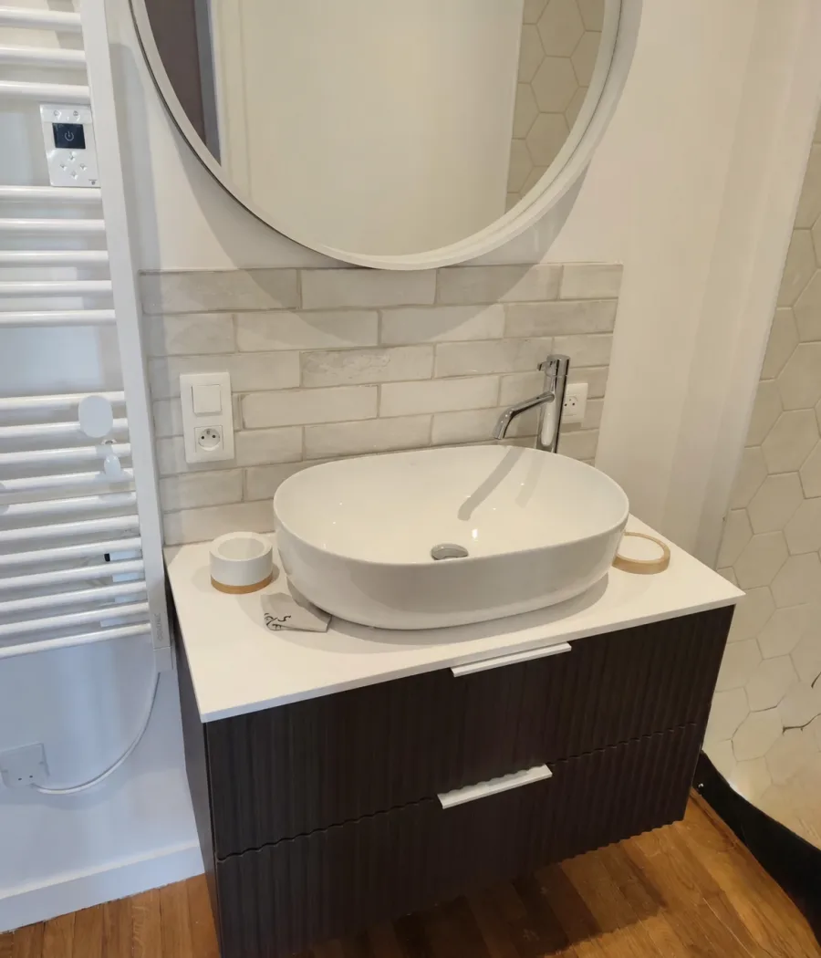 Bathroom with a wood vanity unit and illuminated mirror